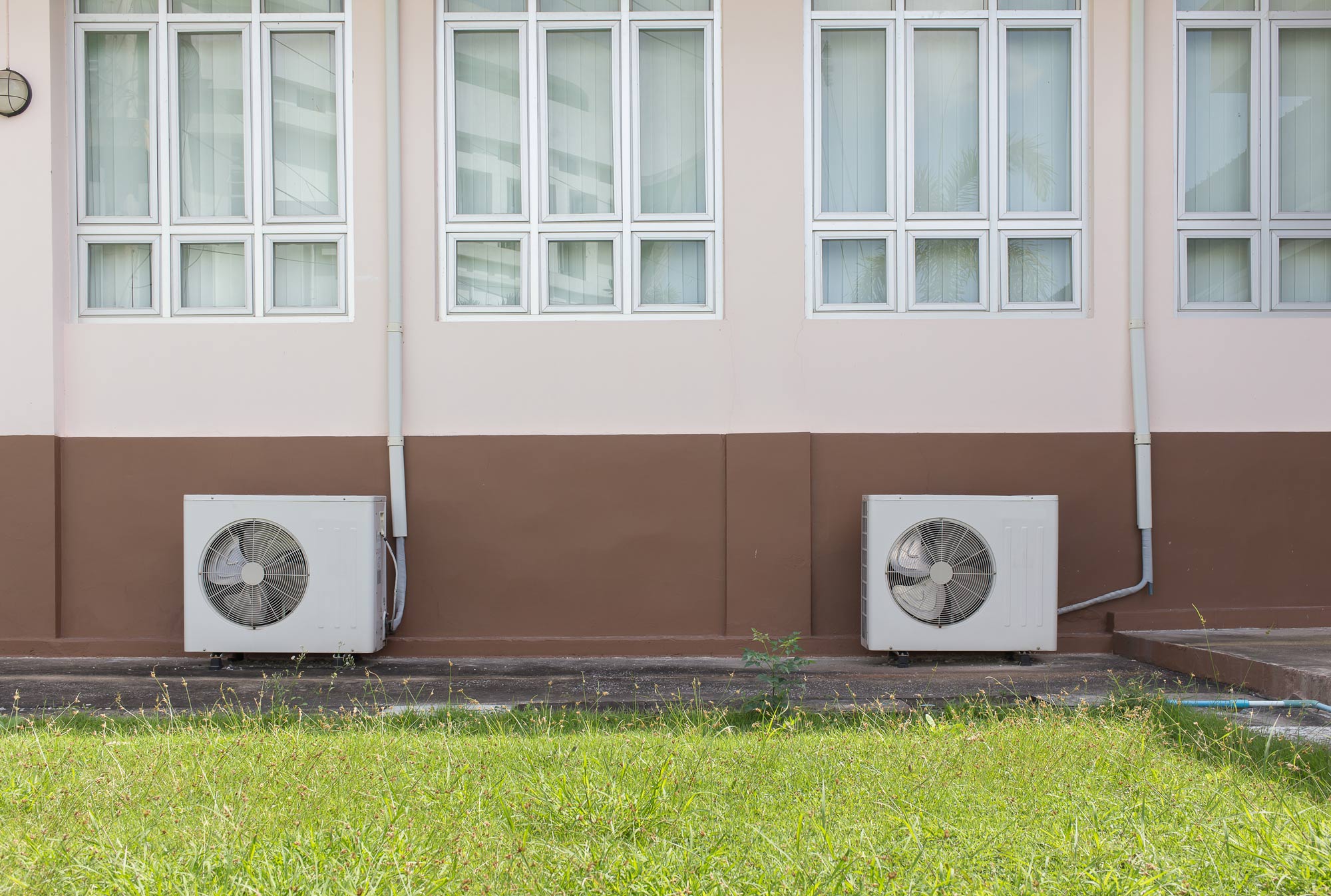 Two sets of heat pumps outside building Essex